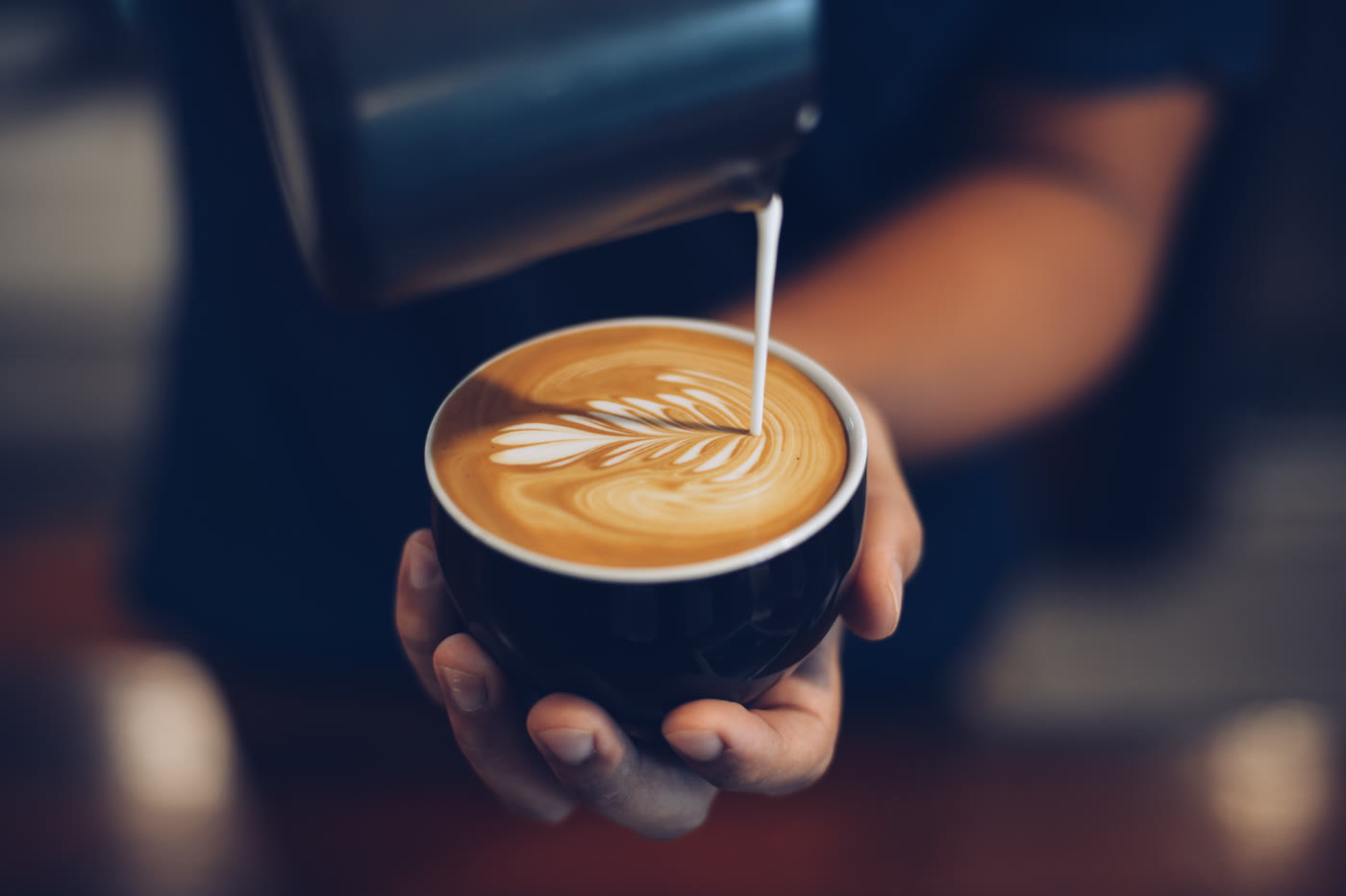 Milk poured into a latte, forming a rosetta